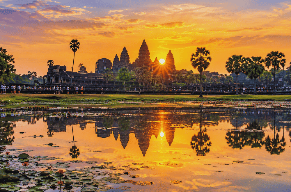 "Angkor Wat Cambodia sunrise reflection pool tourists" 